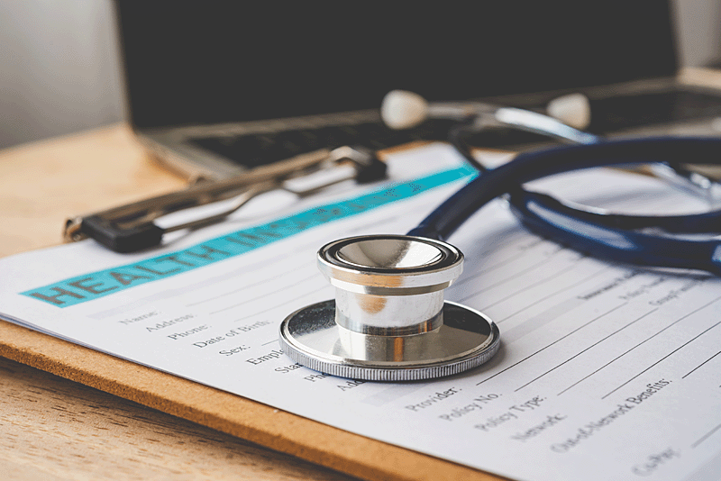 Stethoscope laying on medical records